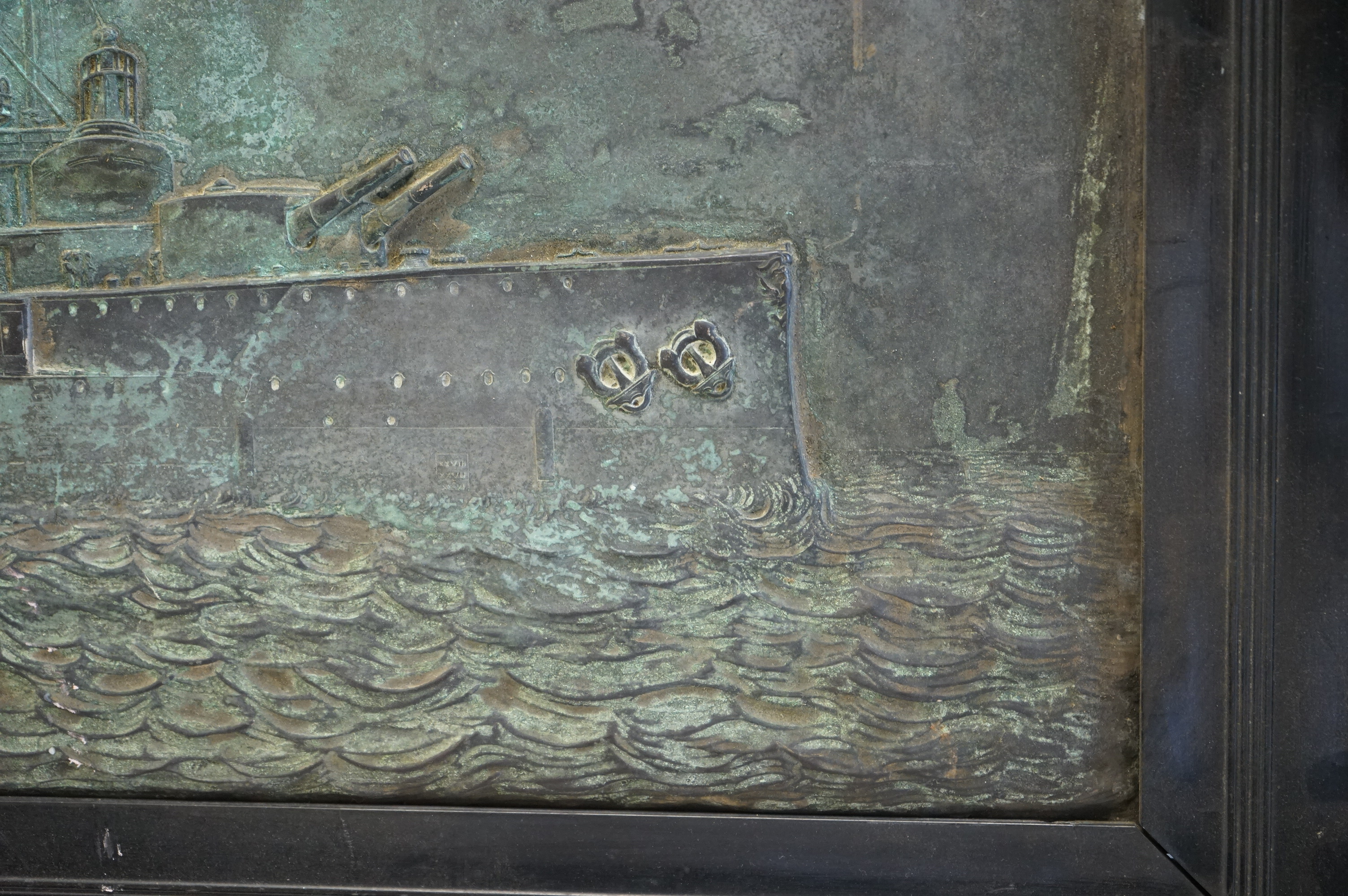 A metal relief panel of a ship, framed, 53cm high